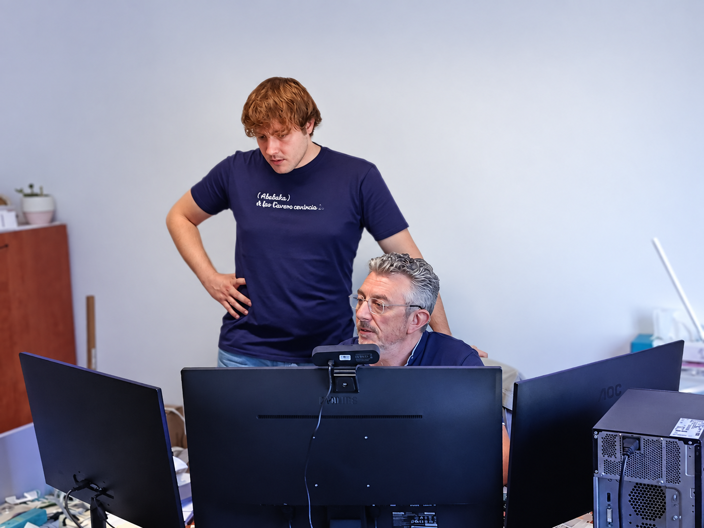 Due persone lavorano insieme davanti alle postazioni informatiche negli uffici VEAS